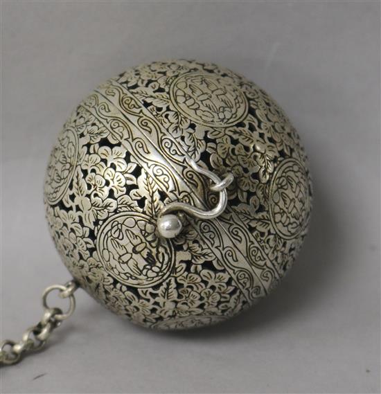 A white metal globe incense burner